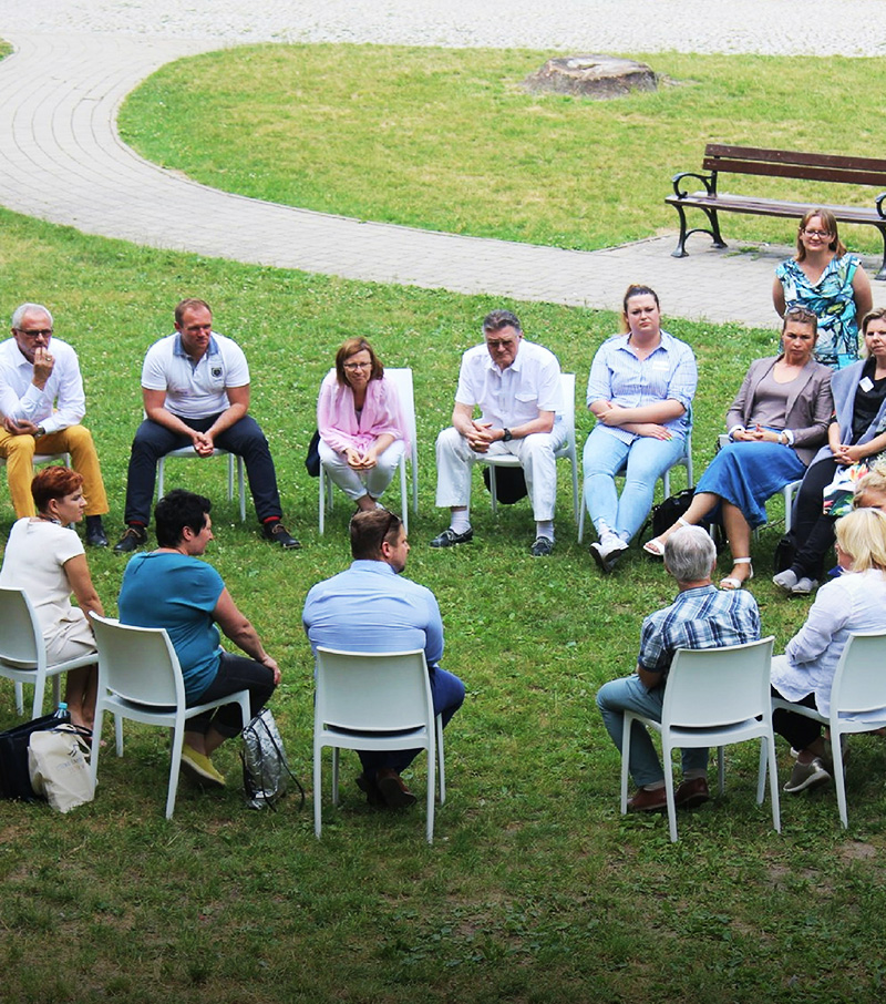 Community group in a circle outdoors